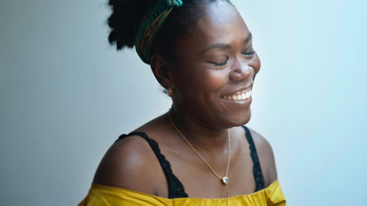 smiling woman with her eyes closed