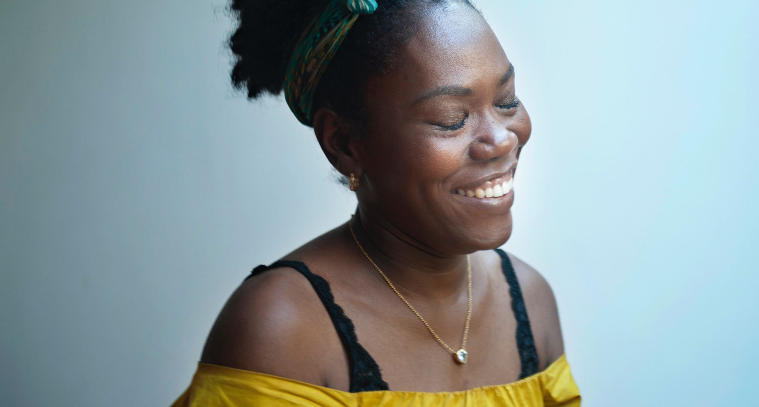 smiling woman with her eyes closed